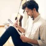 Young male enjoying his drawing and painting time at home.