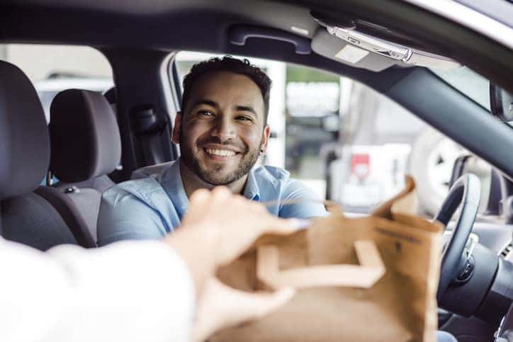 Wesley Chapel Food Scene -Happy Man Receiving Takeout Food in Car