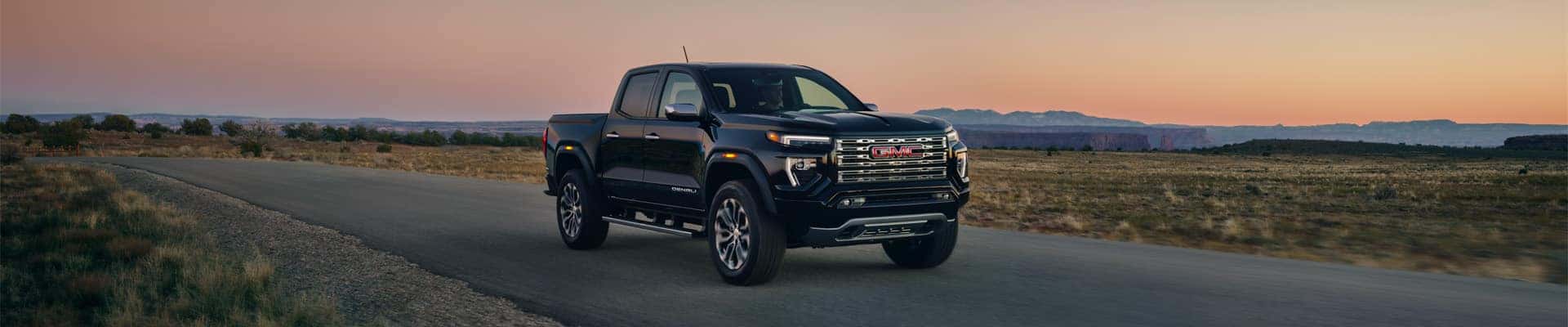 2025 GMC Canyon Denali Crew Cab Short Box in Onyx Black; 3/4 Passengers side Front; Desert background