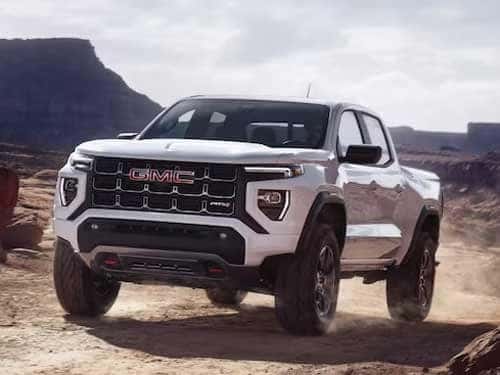2023 GMC Canyon driving up a dirt path