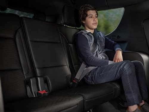 2023 Chevrolet Suburban view of boy sitting in back seat