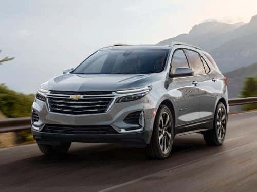 2024 chevrolet equinox exterior view of vehicle driving down a road