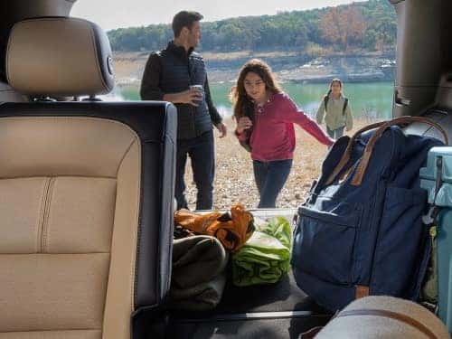2024 Chevrolet Equinox interior view looking out the back door with cargo area full of camping supplies