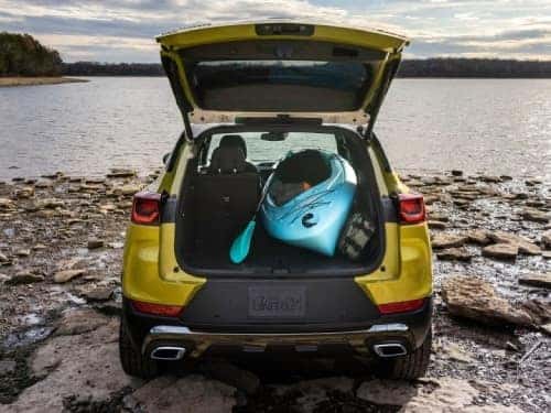 2024 Chevrolet Trailblazer parked near a lake with back door open and kayak in cargo area