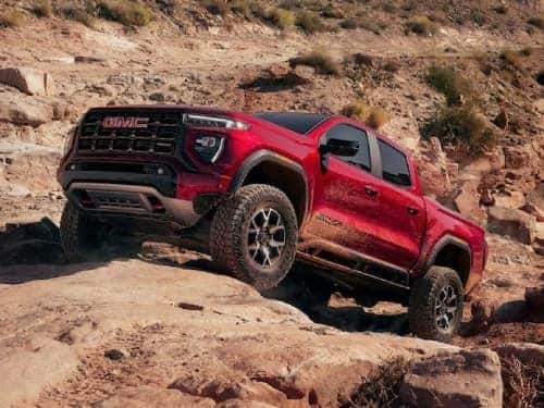 2024 GMC Canyon AT4 offroading up a rocky hill