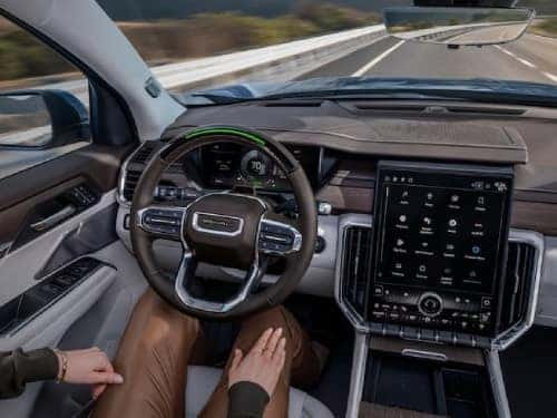 2024 GMC Acadia view of person in driver seat with hands off of wheel while vehicle is in super cruise