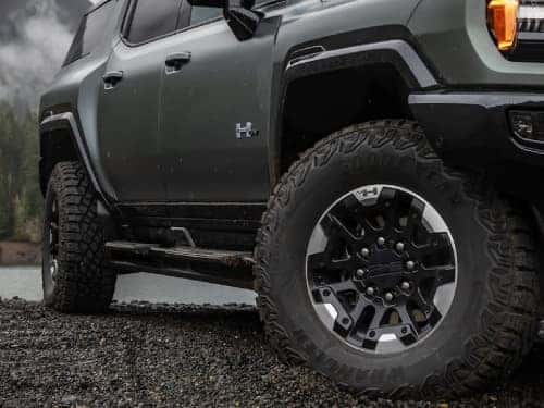 2024 GMC Hummer EV SUV close up exterior view looking up at front side of vehicle