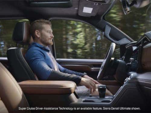 2025 GMC Sierra 1500 view of man in driver's seat with hands on lap while vehicle is in super cruise mode