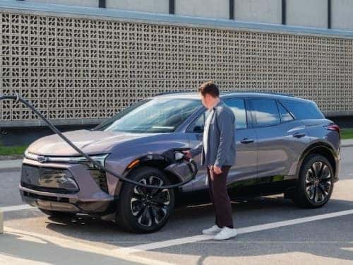 2025 Chevrolet Blazer EV view of man charging vehicle