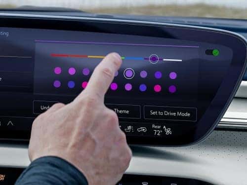 2025 Buick Enclave view of person changing ambient lighting on touchscreen