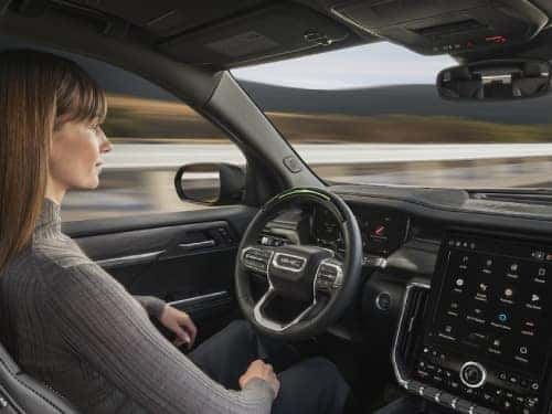 2025 GMC Acadia view of woman in driver's seat while vehicle is in super cruise mode