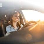 Young woman driving car on a sunny day