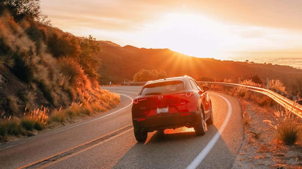Mazda CX-30 on road at sunset