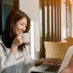 Woman online shopping at the kitchen table