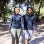 Man and woman walking on a trail after a workout