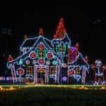 A free-standing christmas lights display of a ginger bread house and three gingerbread men.