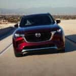 Red Mazda SUV driving on the road