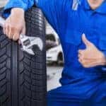 Mechanic giving thumbs up with Mazda tires