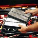 Changing engine air filter as part of a Mazda service schedule