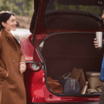 Couple loading the cargo area of a pre-owned Mazda SUV