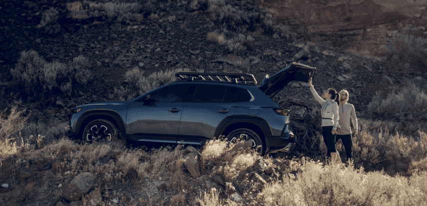 2026 Mazda CX-50 SUV with roof rack and open liftgate outdoors