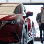 Customers walking through the showroom at a Mazda dealership