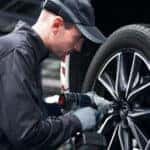 Mazda service technician working on a tire