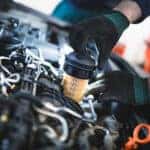 Technician changing an oil filter to improve Mazda fuel efficiency