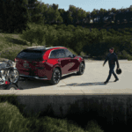 Person walking toward the 2026 Mazda CX-90 PHEV