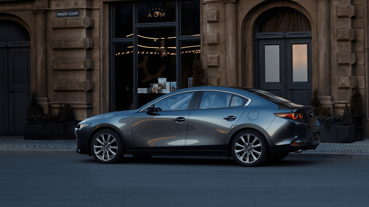 A Mazda sedan parked in the city