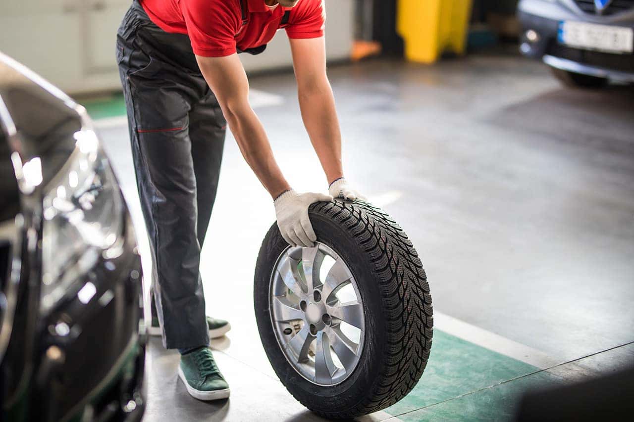 Technician installing new Mazda tires