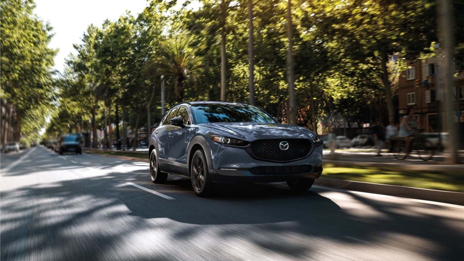 Pre-owned Mazda SUV on the road