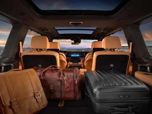 2023 Grand Wagoneer interior view from behind of all seats, cargo area, and touchscreen display