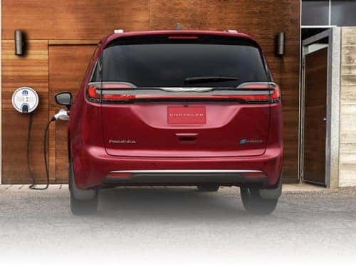 2024 Chrysler Pacifica PHEV exterior view of vehicle parked at home charging