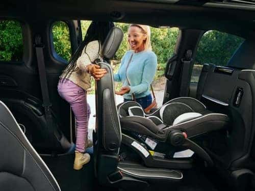 2024 Chrsyler Pacifica PHEV interior view of child getting out of vehicle via sliding side door