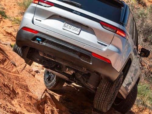 2024 Jeep Grand Cherokee 4xe driving over rocky terrain