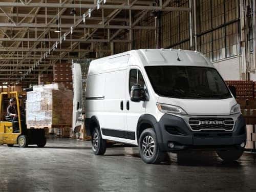 2024 RAM ProMaster parked in a warehouse with a forklift loading boxes into back of van