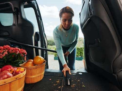 2024 Chrysler Pacifica view of woman vacuuming the back seat floor mats