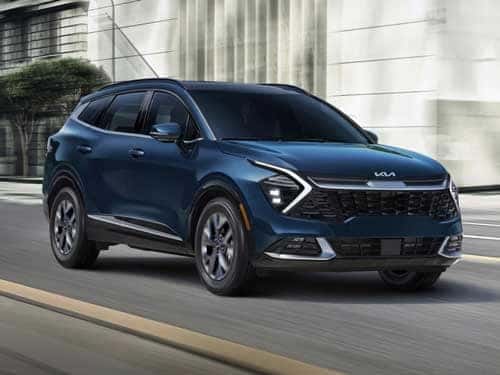 2024 Kia Sportage Hybrid driving down a road