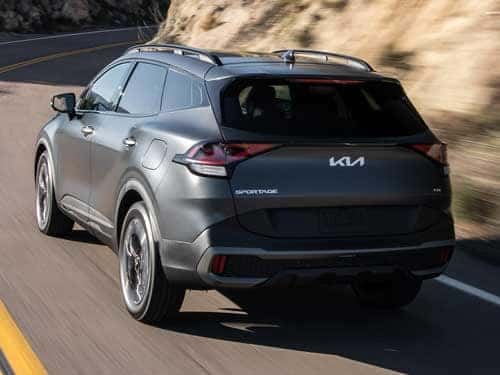 2024 Kia Sportage Plug-in Hybrid driving down a road