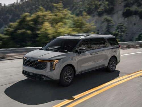 2025 Kia Carnival MPV driving down the highway