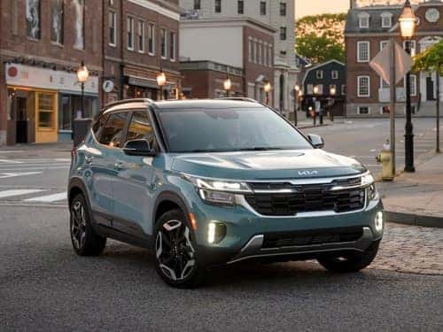 2025 Kia Seltos driving around a corner on a street