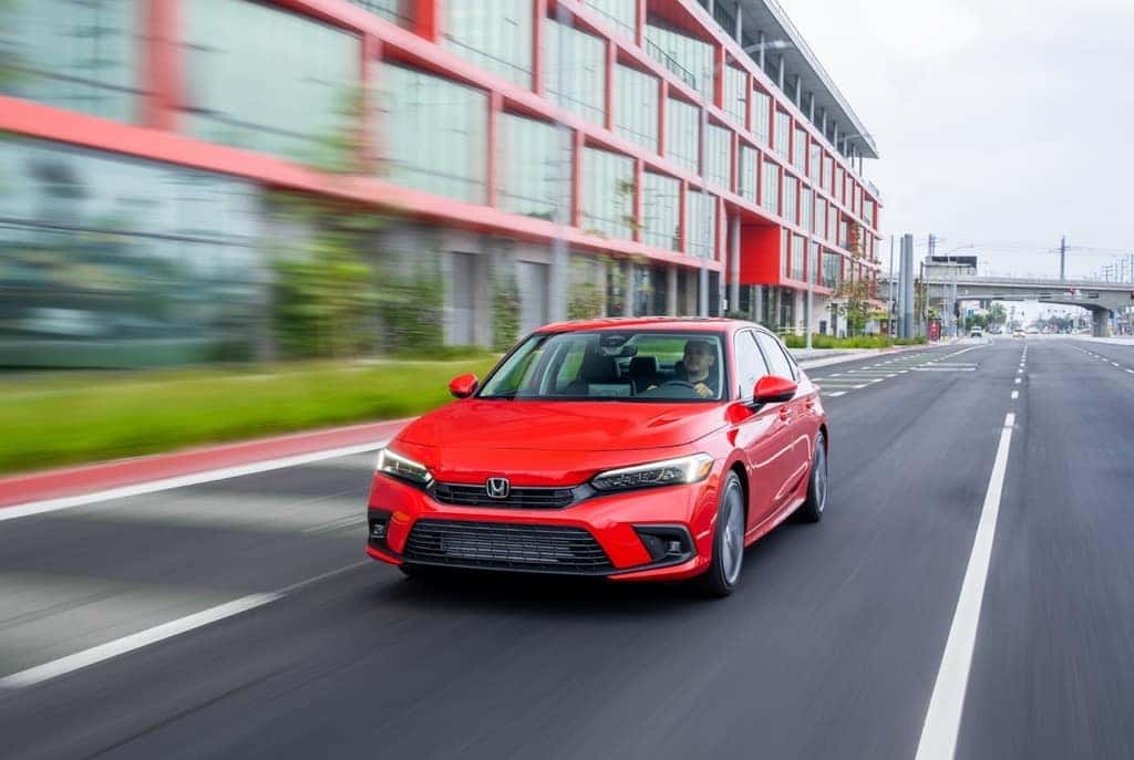 2022 Honda Civic Touring sedan red city at speed