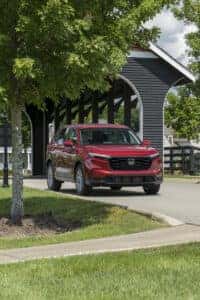 Red Honda CRV driving through covered bridge.