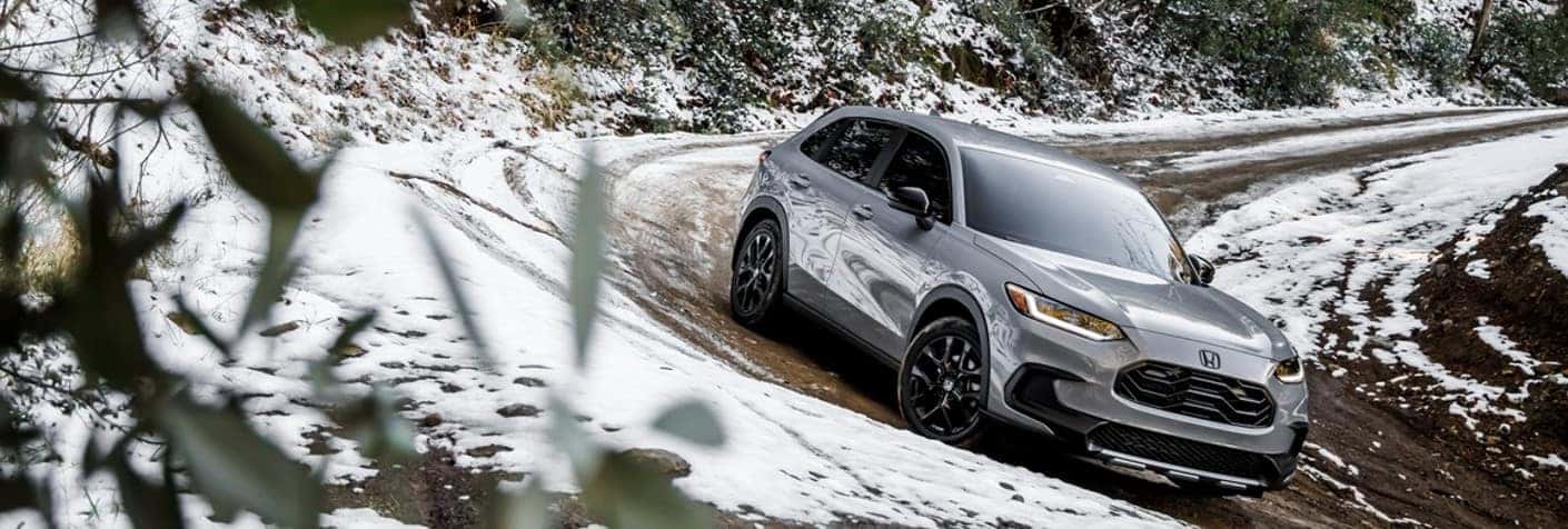 2023 Honda HR-V rounding a snowy cure