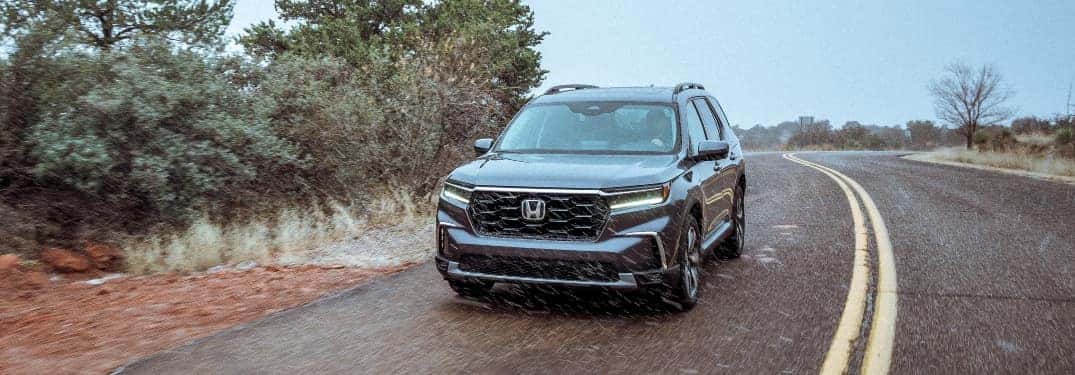 2023 Honda Pilot Driving Down Road in Rain