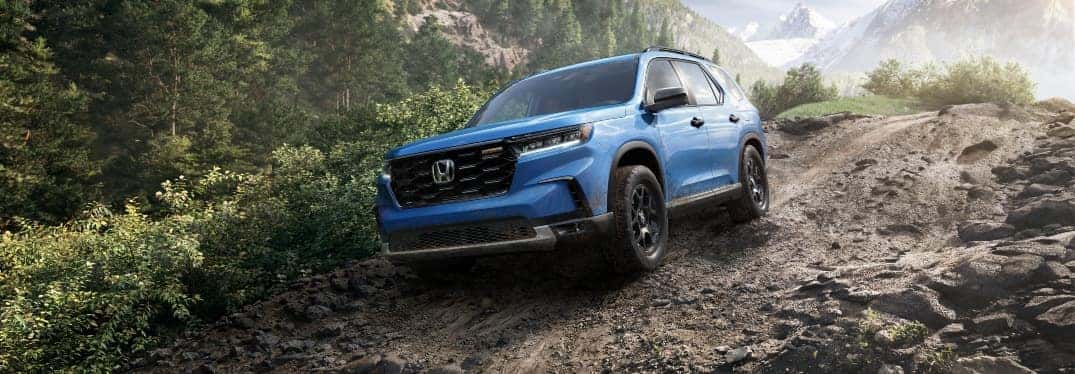 Blue 2023 Honda Pilot Driving in Mountains