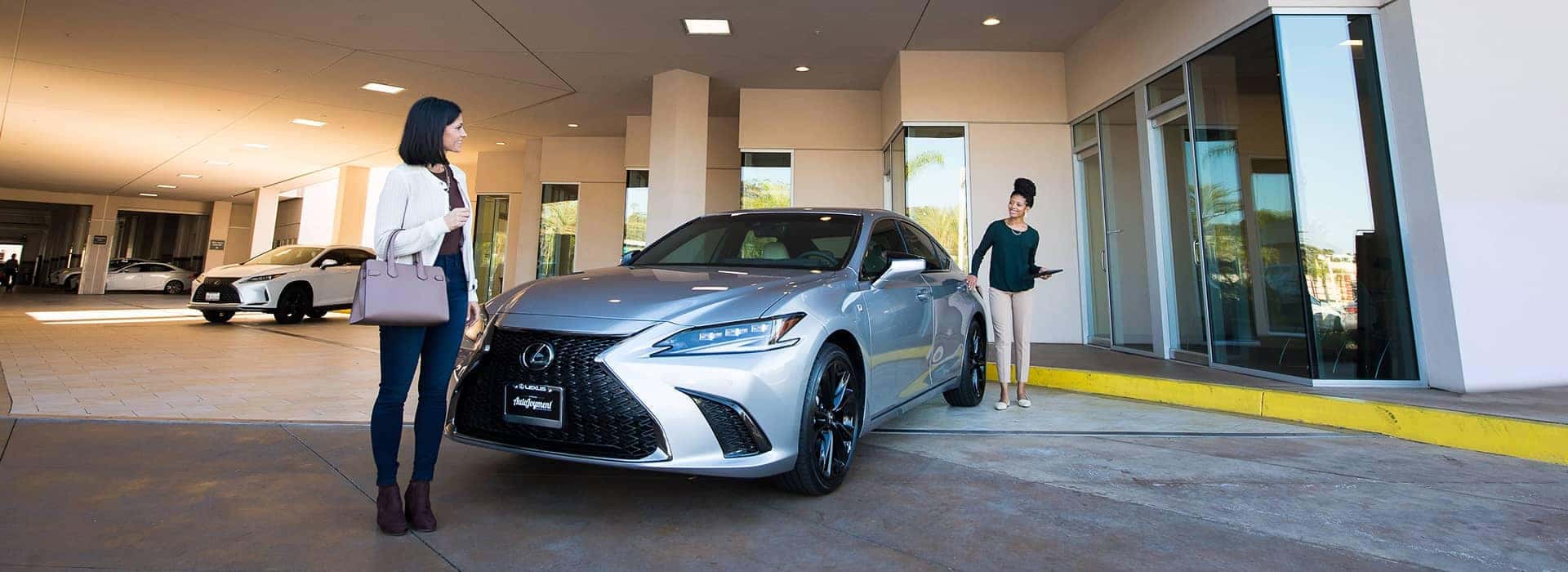 customer service at lexus dealership in front of vehicle