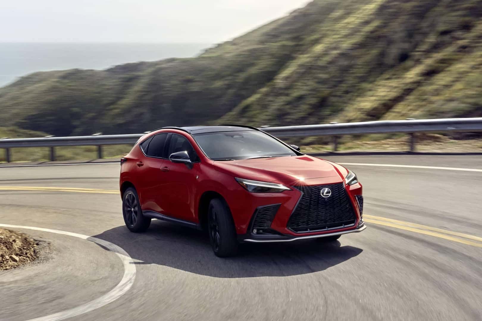 red lexus nx driving on curved road