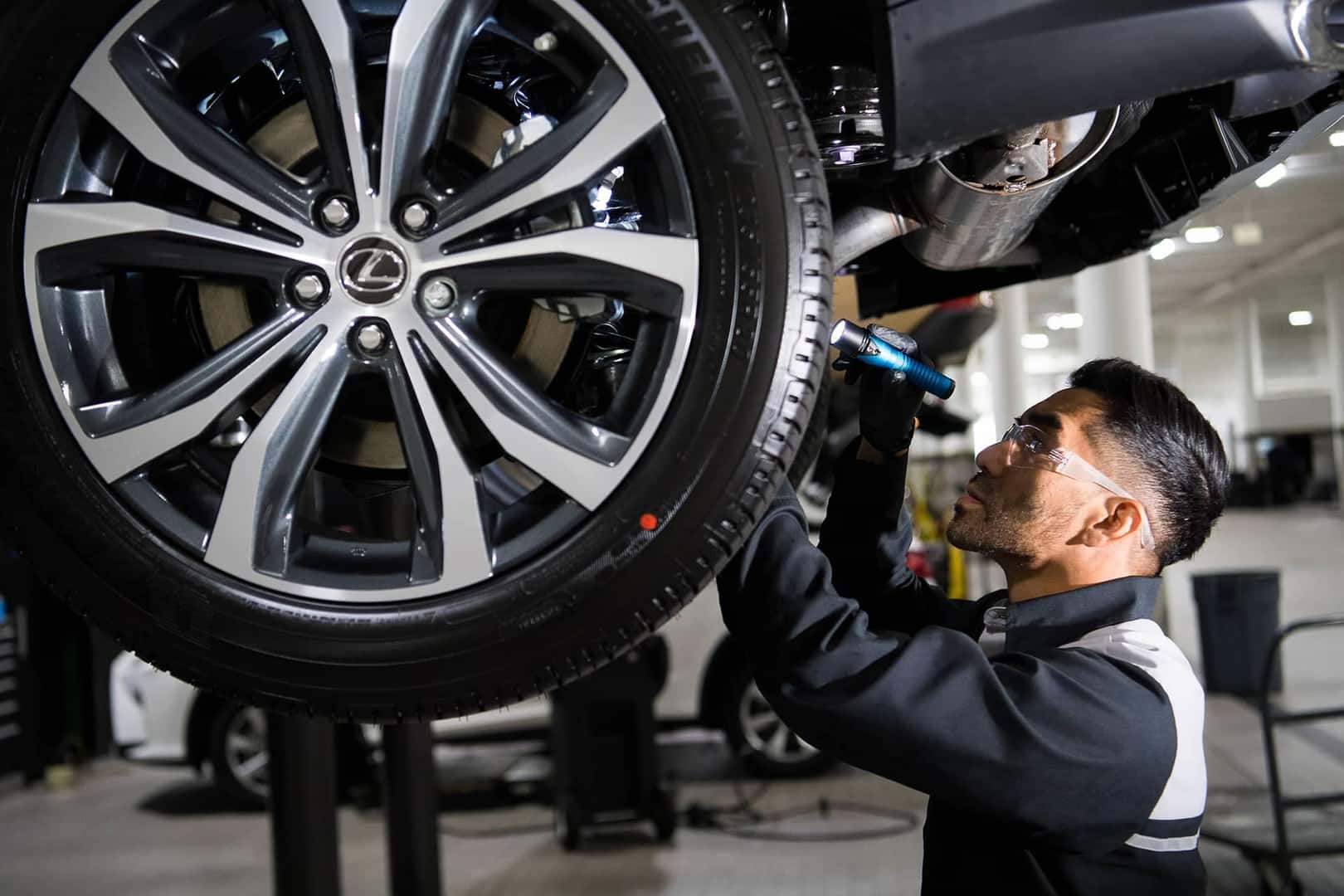 technician working on lexus tire